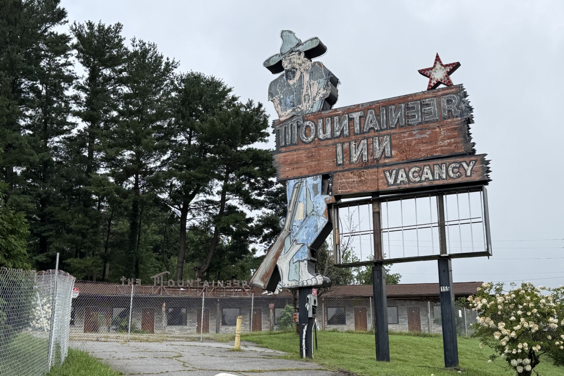 The fenced-off Mountaineer Inn property at 155 Tunnel Road sits vacant in Asheville. City planning records show a preliminary proposal for a Sheetz convenience store and gas station at the longtime motel site, though the project remains in the early review process.