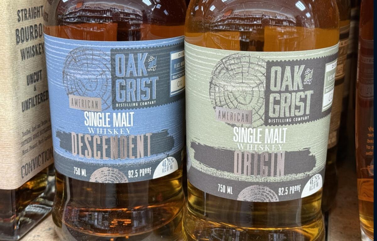 Bottles of Oak & Grist Distilling Co. spirits sit on a shelf at a local retailer. The Black Mountain distillery says it is working to address changes required by town officials related to whiskey barrel storage.