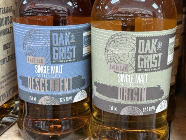 Bottles of Oak & Grist Distilling Co. spirits sit on a shelf at a local retailer. The Black Mountain distillery says it is working to address changes required by town officials related to whiskey barrel storage.