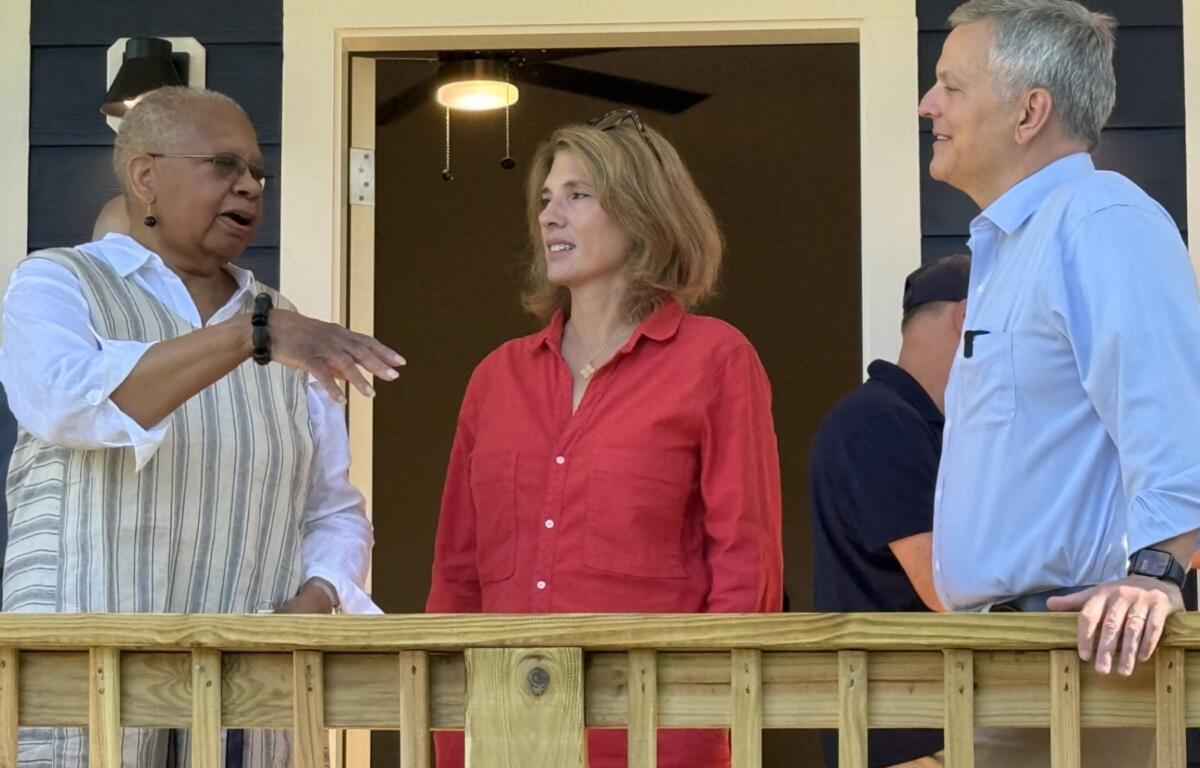 Velma Chapman talks with Gov. Josh Stein and first lady Anna Stein Wednesday during a visit to her new Asheville home.