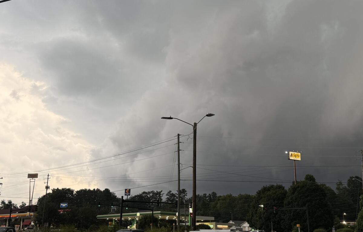 Dark storm clouds hang over West Asheville on Tuesday evening as severe thunderstorms swept across Buncombe County, bringing damaging winds, downed trees and widespread power outages.