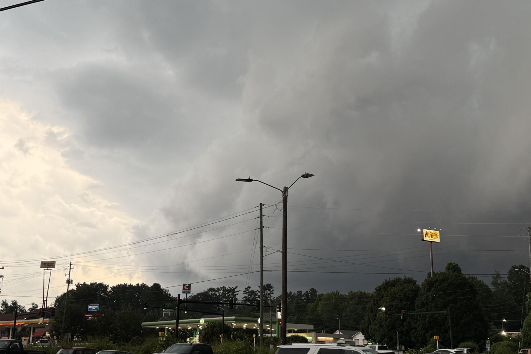 Dark storm clouds hang over West Asheville on Tuesday evening as severe thunderstorms swept across Buncombe County, bringing damaging winds, downed trees and widespread power outages.