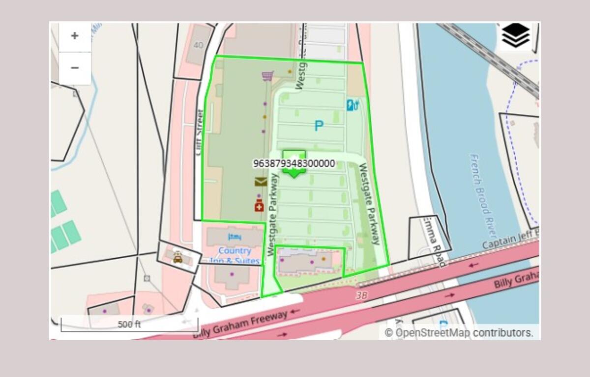 OpenStreetMap-style map with a bright green polygon outlining a block along Westgate Park, near a river and the Billy Graham Freeway; shows a parking area and nearby amenities.