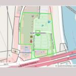 OpenStreetMap-style map with a bright green polygon outlining a block along Westgate Park, near a river and the Billy Graham Freeway; shows a parking area and nearby amenities.