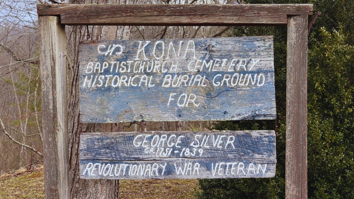 Weathered wooden sign marking Kona Baptist Church Cemetery, honoring George Silver, Revolutionary War veteran (1831–1839).