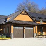 Home with a dark standing-seam metal roof and warm-toned siding.