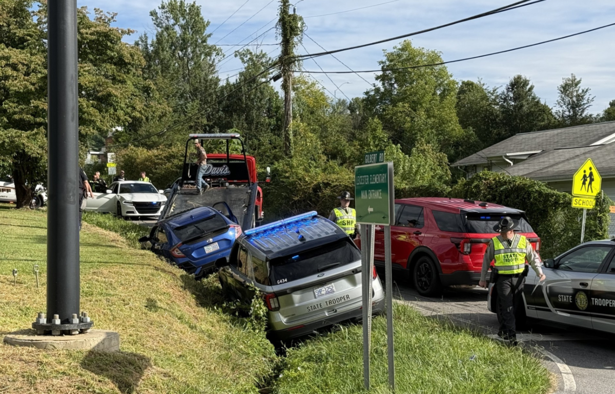 Two vehicles are shown in a ditch along New Leicester Highway near Gilbert Road Tuesday morning as North Carolina State Highway Patrol and Buncombe County Sheriff's Office deputies responded to the scene.