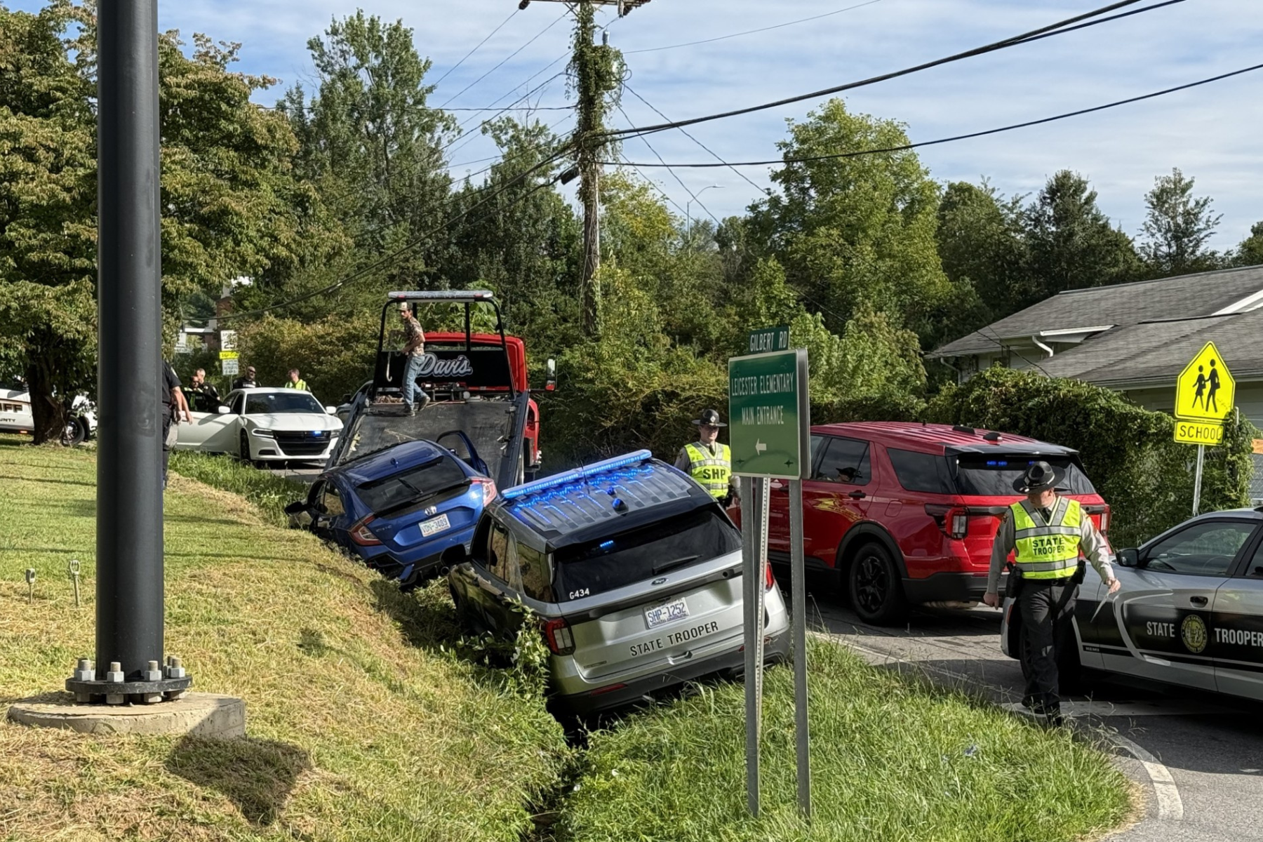 Two vehicles are shown in a ditch along New Leicester Highway near Gilbert Road Tuesday morning as North Carolina State Highway Patrol and Buncombe County Sheriff's Office deputies responded to the scene.
