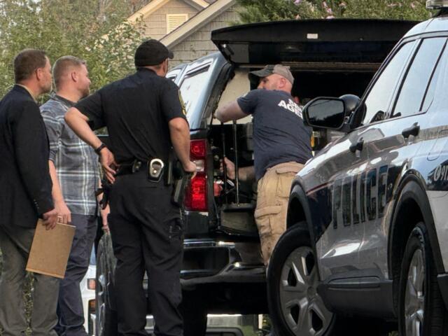 SBI and Asheville Police Department officers investigate the scene Thursday, Aug. 27, 2026, on Nancy Street after an officer-involved shooting left a man dead.