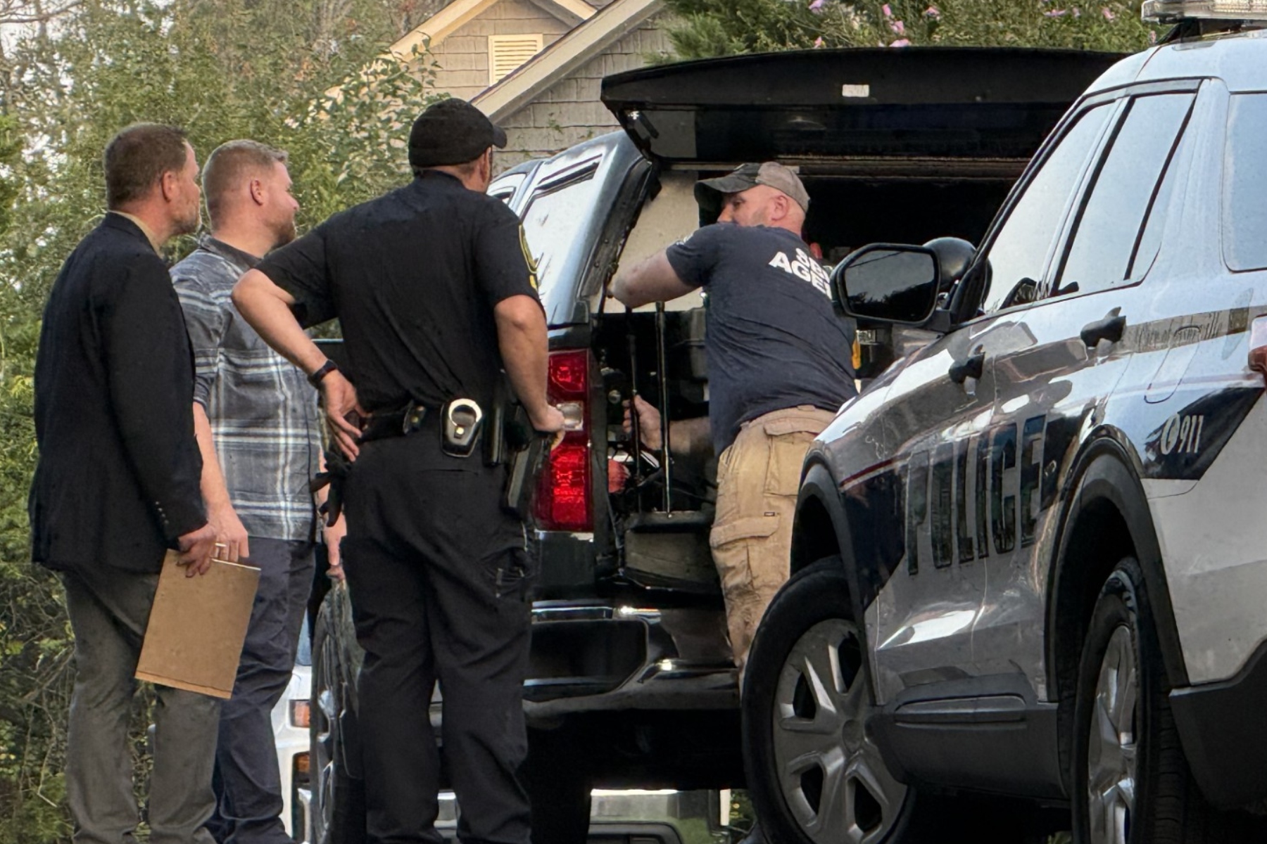 SBI and Asheville Police Department officers investigate the scene Thursday, Aug. 27, 2026, on Nancy Street after an officer-involved shooting left a man dead.
