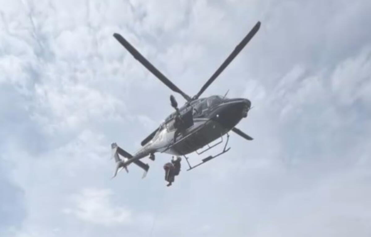 A North Carolina State Highway Patrol helicopter takes part in the rescue of a hiker who fell about 50 feet at Grandfather Mountain.