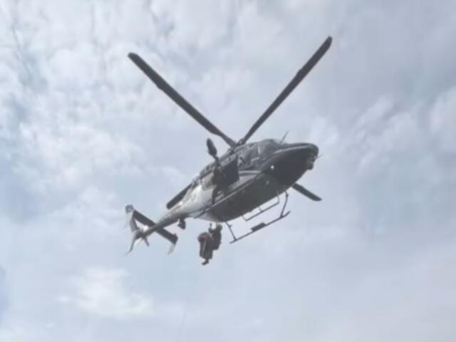 A North Carolina State Highway Patrol helicopter takes part in the rescue of a hiker who fell about 50 feet at Grandfather Mountain.