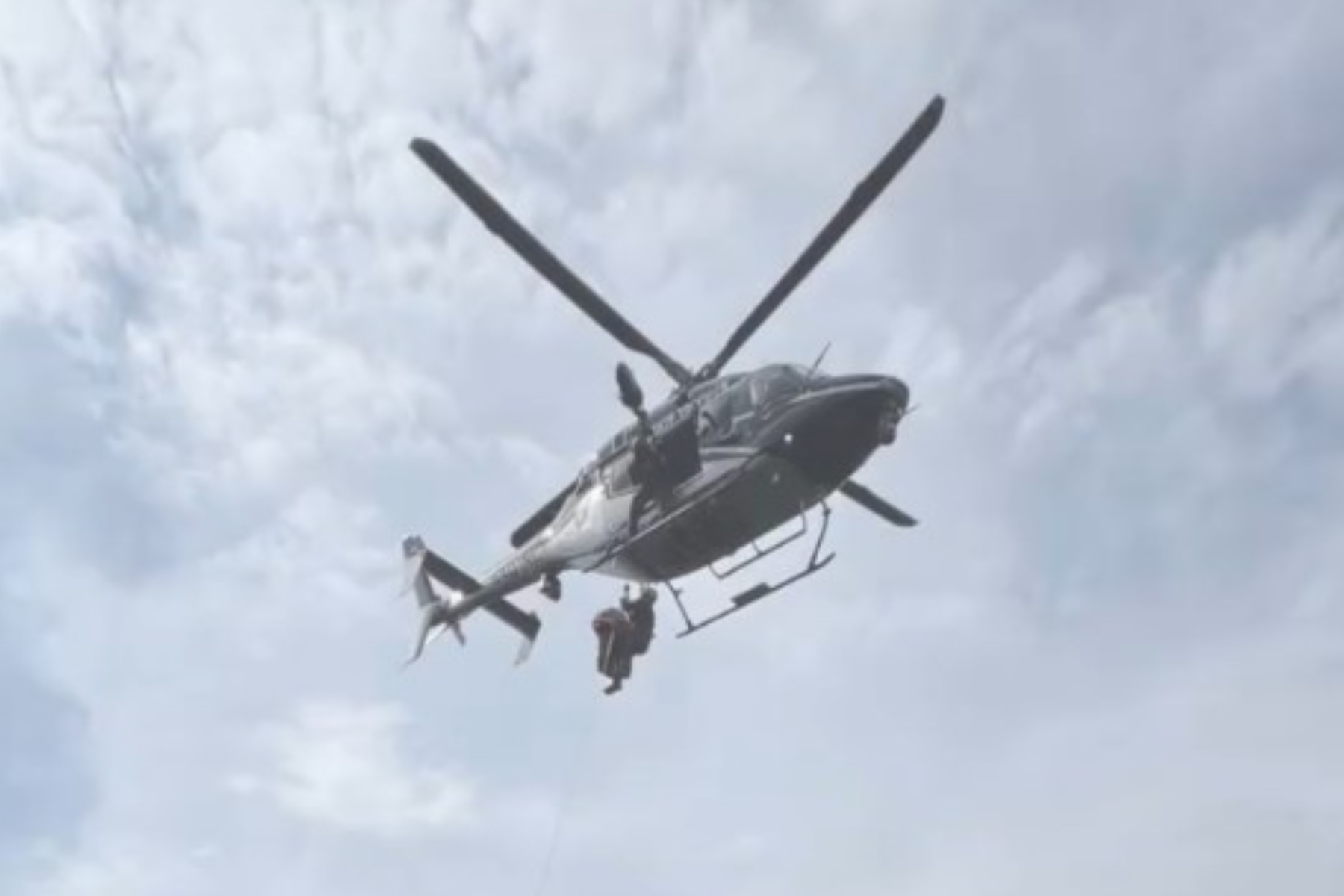 A North Carolina State Highway Patrol helicopter takes part in the rescue of a hiker who fell about 50 feet at Grandfather Mountain.