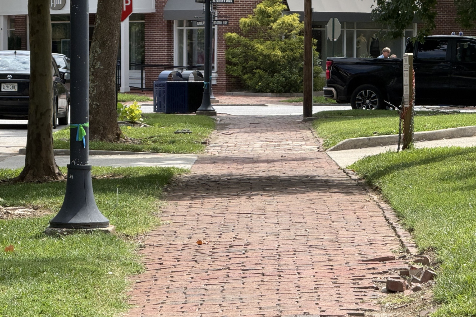 A brick sidewalk along Kitchin Place near Boston Way in Biltmore Village shows signs of wear following Tropical Storm Helene. Asheville is planning repairs to sidewalks, curbs, trees and other infrastructure in the historic district.