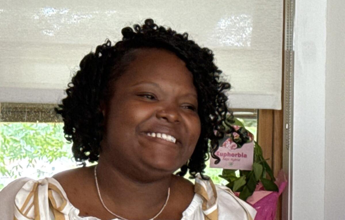 Shaniqua Simuel, a neighborhood navigator with the Shiloh Community Association, discusses the challenges facing younger residents and the importance of preserving generational homeownership during a neighborhood walk Wednesday, Aug. 12, 2026, in Asheville.
