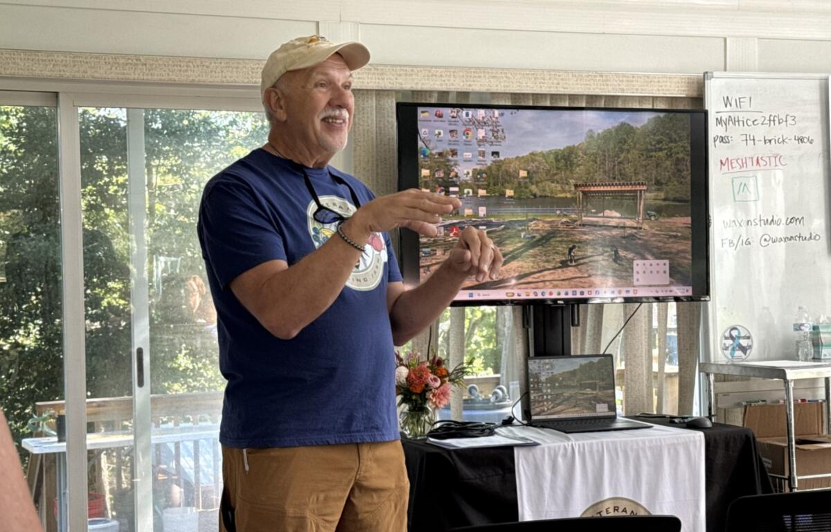 Michael Morano, lead beekeeper at the Veterans Healing Farm and a retired U.S. Coast Guard member, talks about the farm’s beekeeping program during a North Carolina Governor’s Working Group Collaboration Lab on Tuesday, Aug. 18, 2026, in Mills River. Morano said beekeeping has become an important source of community and connection for him.