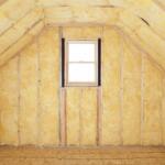 Unfinished attic with yellow insulation between wall studs and a small centered window on the back wallUnfortunately this is too long to display properly.
