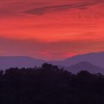 The sun sets over the Blue Ridge Mountains near Asheville, adding to the peaceful scenery that draws visitors to the region.
