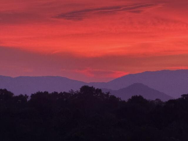 The sun sets over the Blue Ridge Mountains near Asheville, adding to the peaceful scenery that draws visitors to the region.