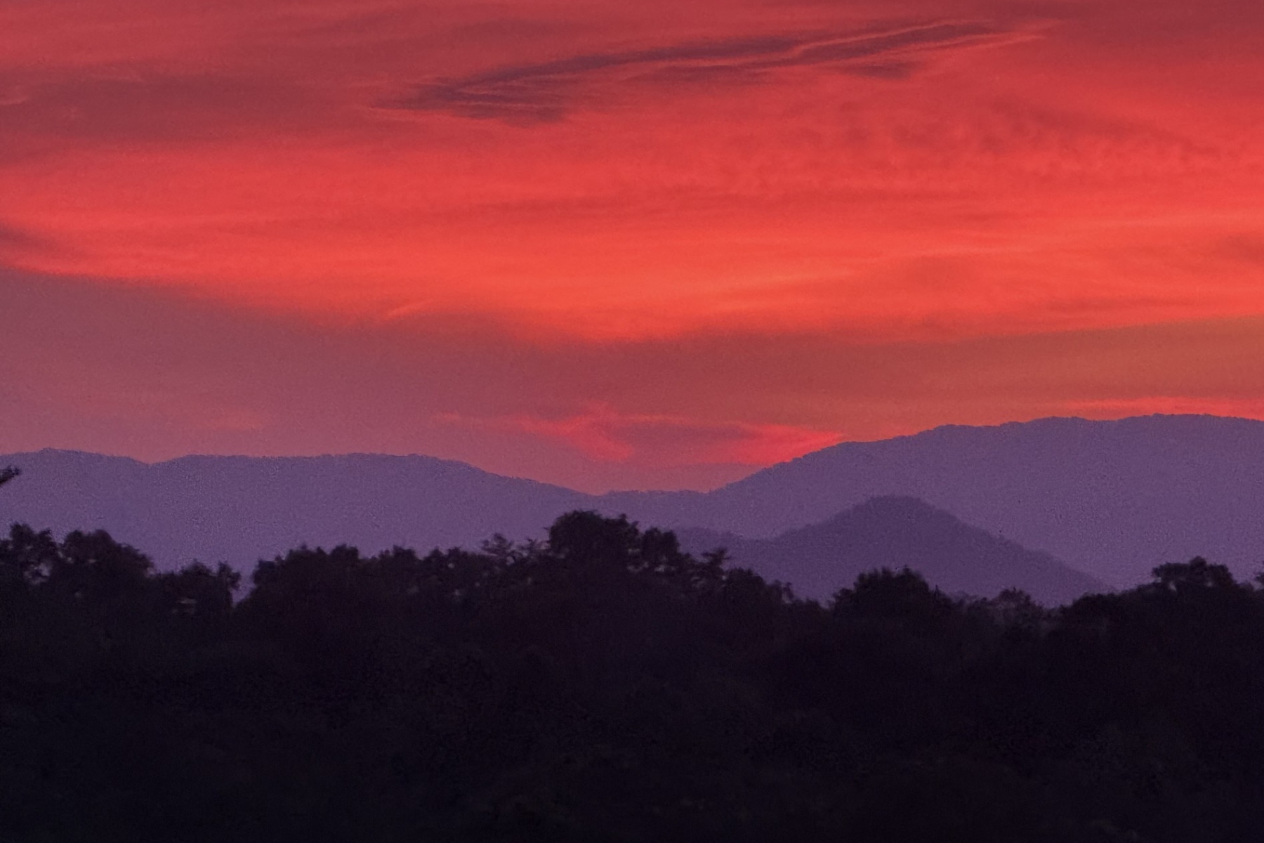 The sun sets over the Blue Ridge Mountains near Asheville, adding to the peaceful scenery that draws visitors to the region.