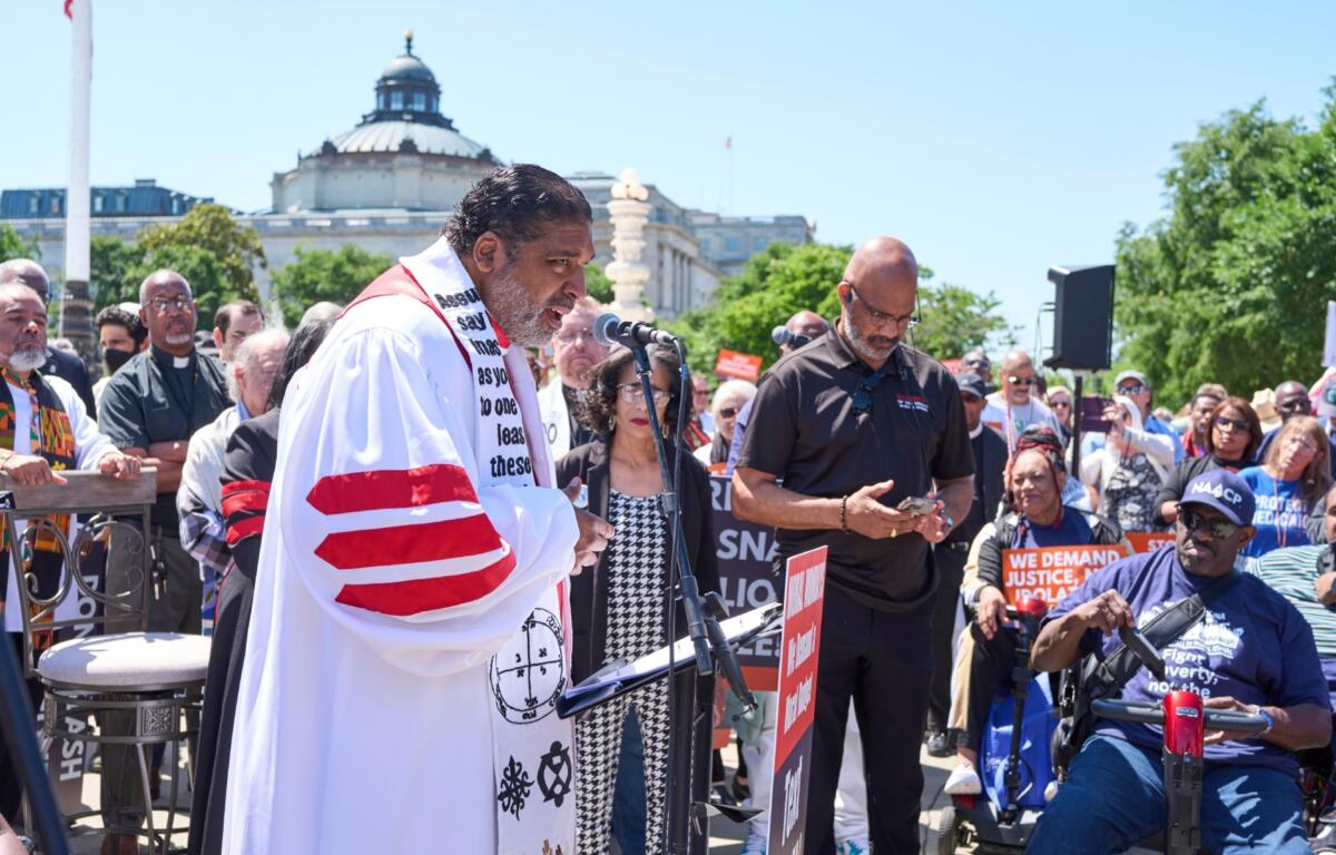 Activists with the Poor People's Campaign led by Rev. William Barber, left, protest against spending reductions across Medicaid, food stamps and federal aid in President Donald Trump's spending and tax bill being worked on by Senate Republicans this week, outside the Supreme Court in Washington, Monday, June 2, 2025. (AP Photo/J. Scott Applewhite)