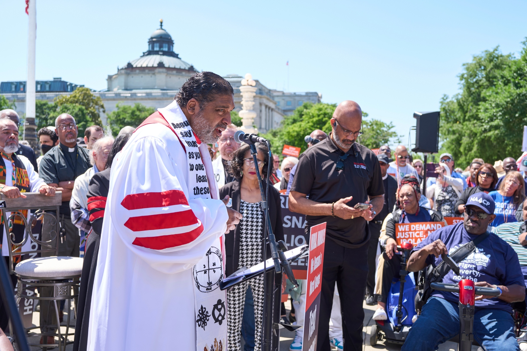 Activists with the Poor People's Campaign led by Rev. William Barber, left, protest against spending reductions across Medicaid, food stamps and federal aid in President Donald Trump's spending and tax bill being worked on by Senate Republicans this week, outside the Supreme Court in Washington, Monday, June 2, 2025. (AP Photo/J. Scott Applewhite)