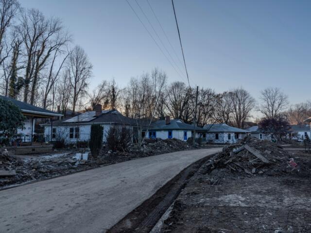 Piles of debris sit in front of homes in Swannanoa, N.C., Tuesday, Dec. 3, 2024, after damage from Hurricane Helene. (AP Photo/Stephanie Scarbrough)