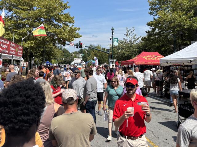 Festivalgoers enjoy the sights, sounds and food at the annual North Carolina Apple Festival in downtown Hendersonville.