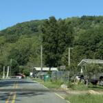 Deaverview Mountain rises behind homes along Deaverview Road in Asheville. Buncombe County purchased the 342-acre mountain in March and plans to develop it as a public park.