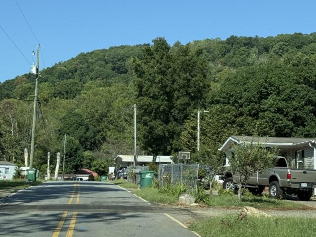 Deaverview Mountain rises behind homes along Deaverview Road in Asheville. Buncombe County purchased the 342-acre mountain in March and plans to develop it as a public park.