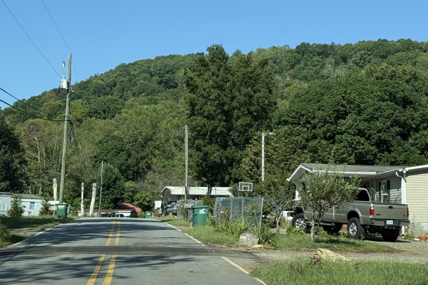 Deaverview Mountain rises behind homes along Deaverview Road in Asheville. Buncombe County purchased the 342-acre mountain in March and plans to develop it as a public park.