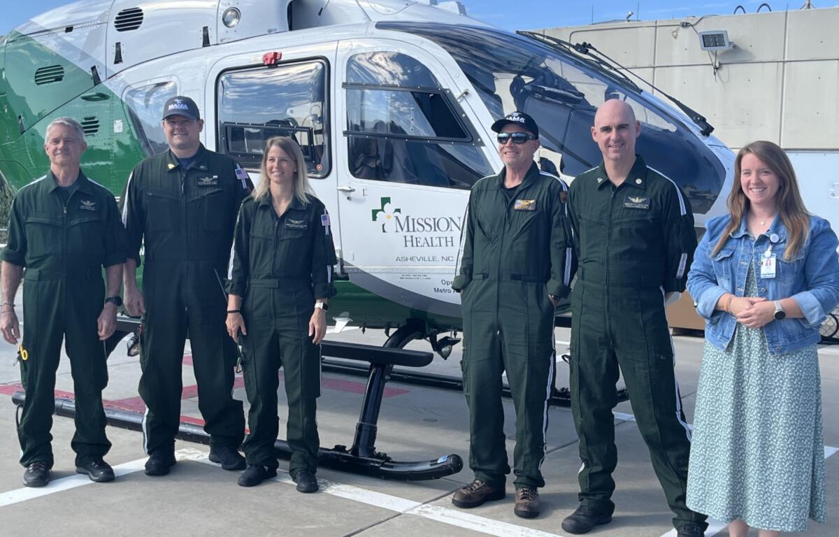 Members of the Mountain Area Medical Airlift crew stand in front of a MAMA helicopter. The service operates two helicopters, one based at Mission Hospital in Asheville and another in Franklin, and has flown more than 31,000 patients since 1986.
