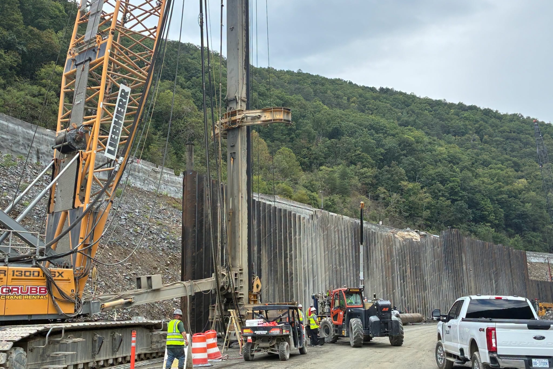 Crews work on the reconstruction of Interstate 40 through the Pigeon River Gorge, where Tropical Storm Helene caused extensive damage in September 2024.