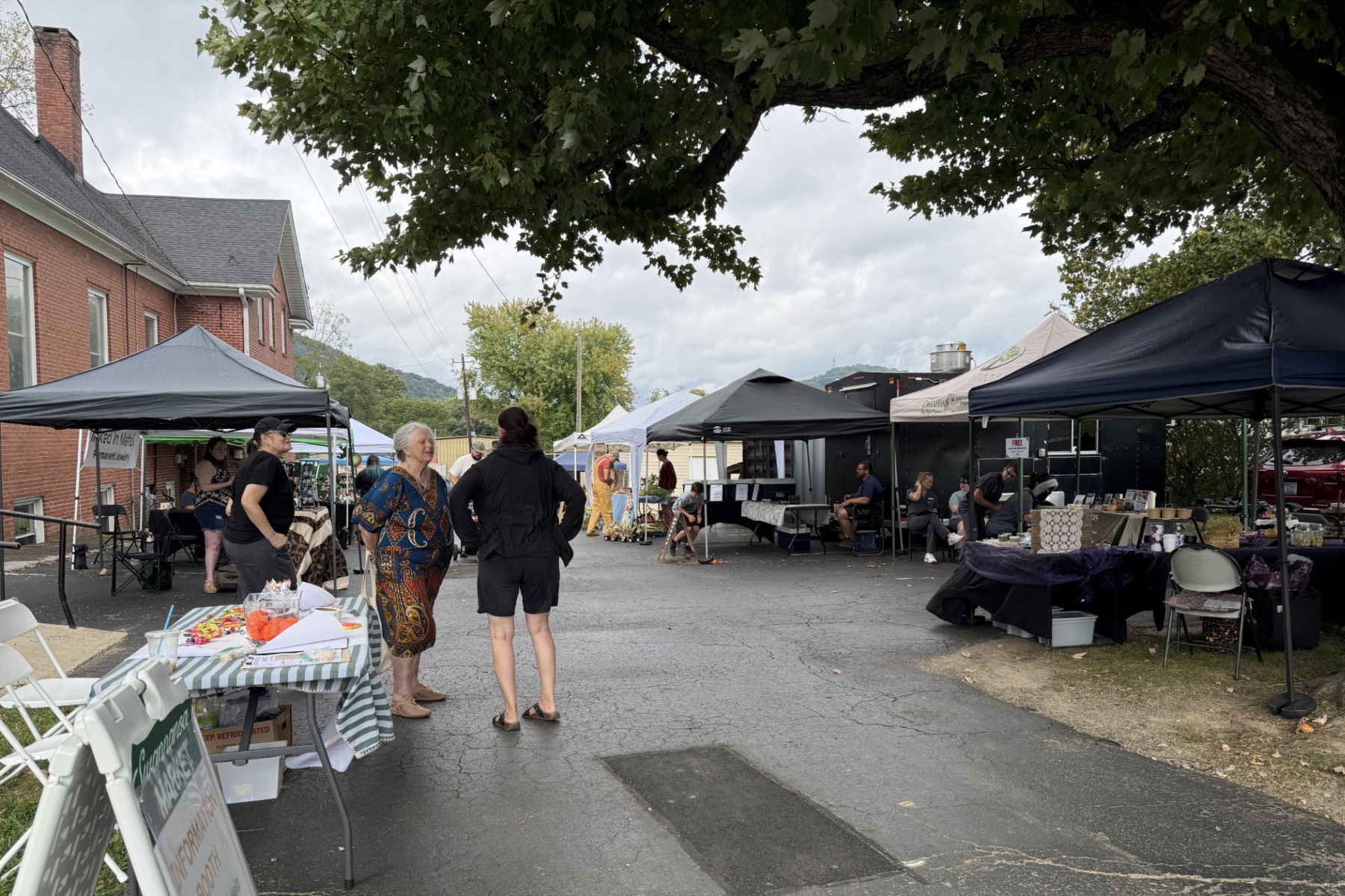 Vendors and visitors gather at the Swannanoa Market, part of the Swannanoa Resilience Hub’s efforts to support local businesses and bring the community together nearly two years after Tropical Storm Helene.