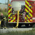 An Asheville firefighter works at the scene of a fire on Riverside Drive. The Asheville Fire Department says I-26 Connector construction has forced crews responding in the Hill Street and Riverside Drive area to adjust their routes.
