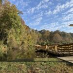 A wooden viewing dock overlooks Azalea Pond at Asheville's Azalea Park, where the city's first AVL Unpaved natural-surface trail has opened. The 3,600-foot trail is available for hiking, running and mountain biking.