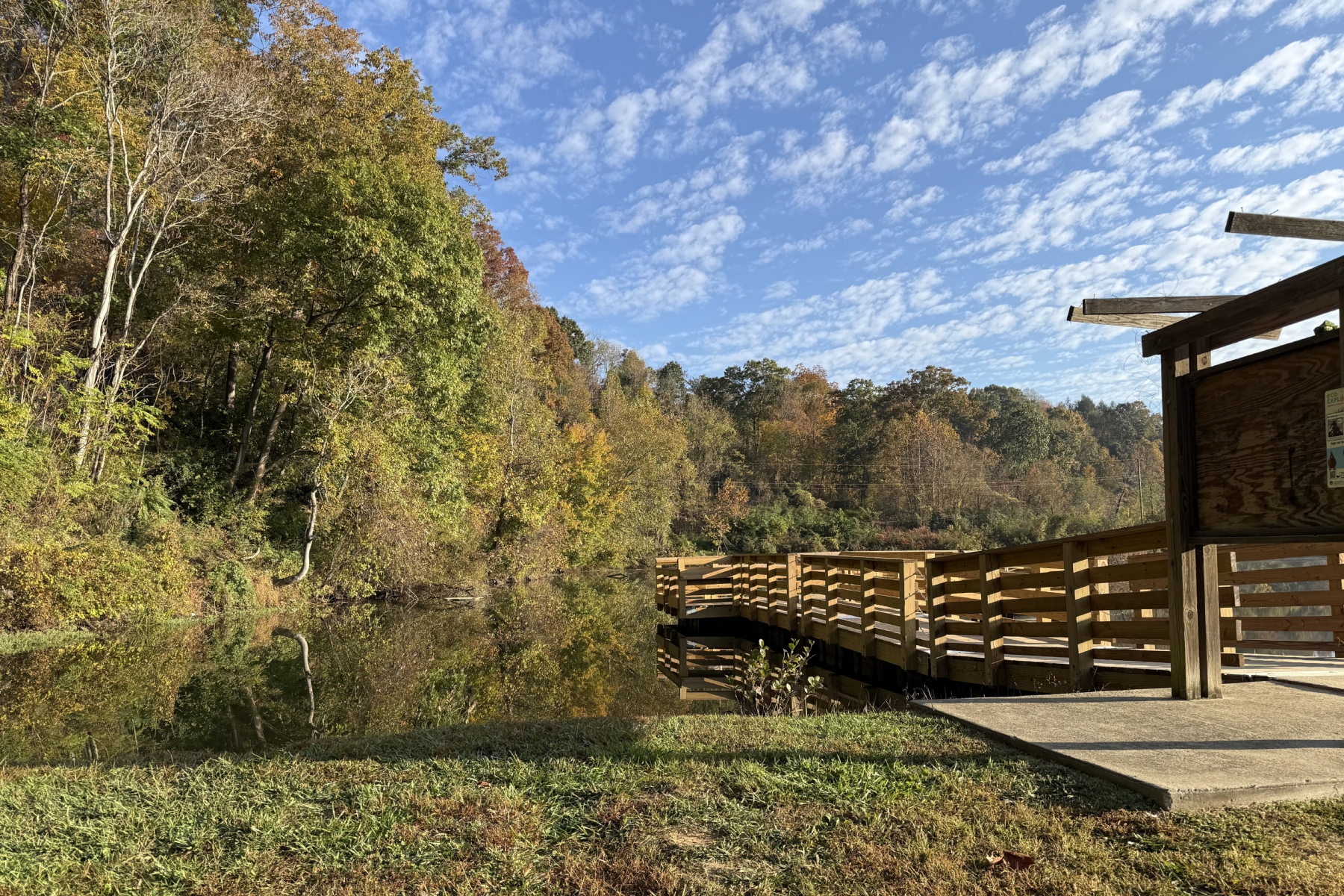 A wooden viewing dock overlooks Azalea Pond at Asheville's Azalea Park, where the city's first AVL Unpaved natural-surface trail has opened. The 3,600-foot trail is available for hiking, running and mountain biking.