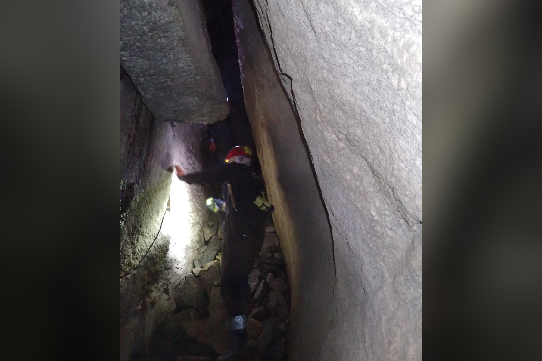 Explorers navigate a narrow passage between towering rock walls inside Bat Cave in Henderson County. The cave, known for its unusual geological formations and legends of buried treasure, is protected by The Nature Conservancy and closed to the public. (Photo by Sue Cameron/U.S. Fish and Wildlife Service)
