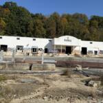 An overgrown property along Swannanoa River Road in Asheville is part of the site proposed for a 524-unit apartment development. The project has raised concerns among city design reviewers about flooding and emergency evacuation routes.