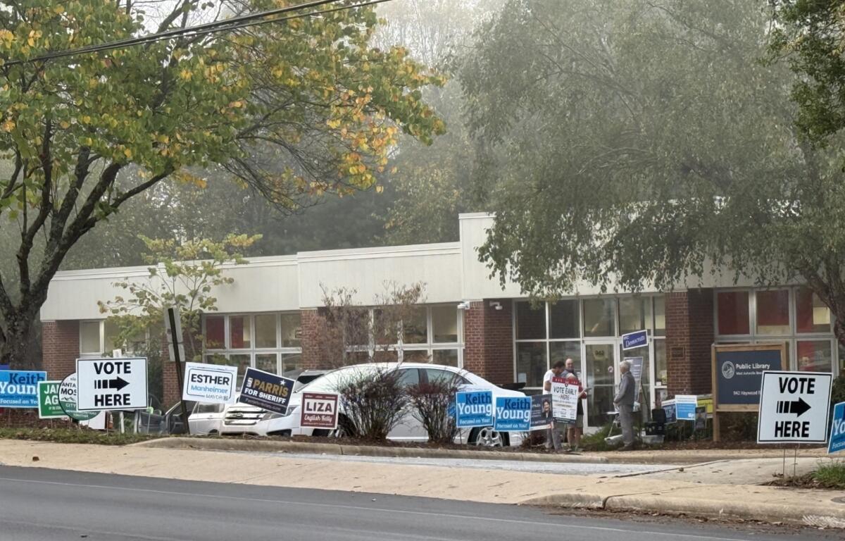 Campaign signs line the entrance to West Asheville Branch Library, one of Buncombe County's 13 early voting locations. More than 7,000 people cast ballots across the county Thursday, Oct. 15, the first day of early voting for the Nov. 3 general election.