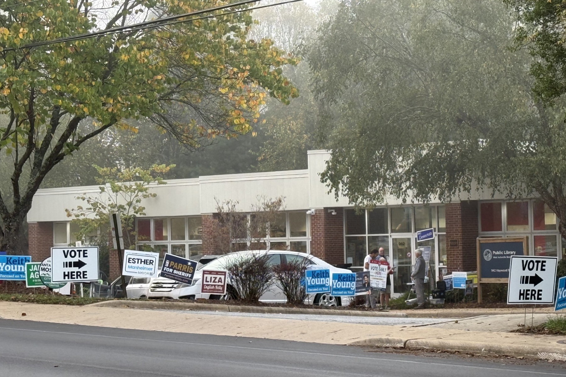 Campaign signs line the entrance to West Asheville Branch Library, one of Buncombe County's 13 early voting locations. More than 7,000 people cast ballots across the county Thursday, Oct. 15, the first day of early voting for the Nov. 3 general election.