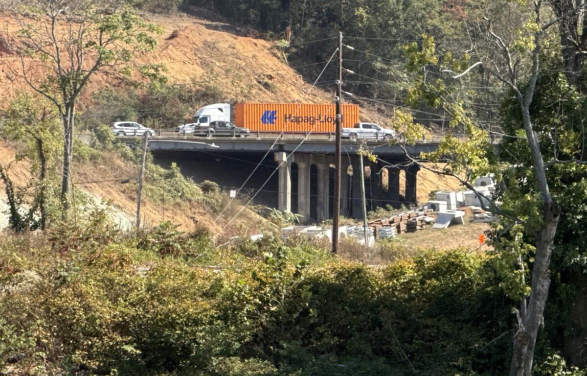 Traffic moves through the I-26 Connector construction zone in Asheville, seen from across the French Broad River.