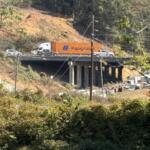 Traffic moves through the I-26 Connector construction zone in Asheville, seen from across the French Broad River.
