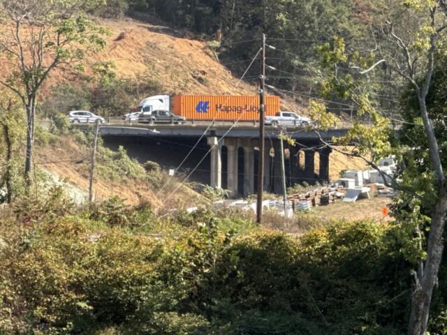 Traffic moves through the I-26 Connector construction zone in Asheville, seen from across the French Broad River.
