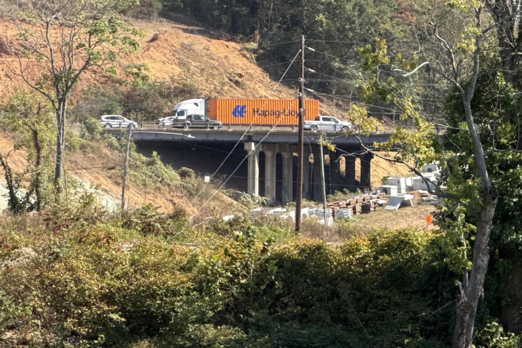Traffic moves through the I-26 Connector construction zone in Asheville, seen from across the French Broad River.
