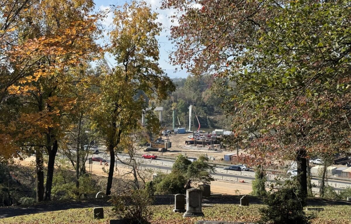Construction continues on the future Interstate 26 Connector near Broadway in Asheville, as seen from Riverside Cemetery. The project remains on schedule, with additional lane closures and rolling roadblocks planned for Oct. 18-22, 2026.