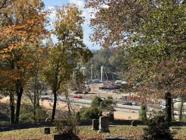 Construction continues on the future Interstate 26 Connector near Broadway in Asheville, as seen from Riverside Cemetery. The project remains on schedule, with additional lane closures and rolling roadblocks planned for Oct. 18-22, 2026.