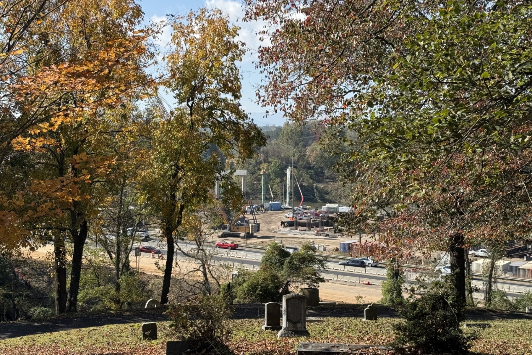 Construction continues on the future Interstate 26 Connector near Broadway in Asheville, as seen from Riverside Cemetery. The project remains on schedule, with additional lane closures and rolling roadblocks planned for Oct. 18-22, 2026.