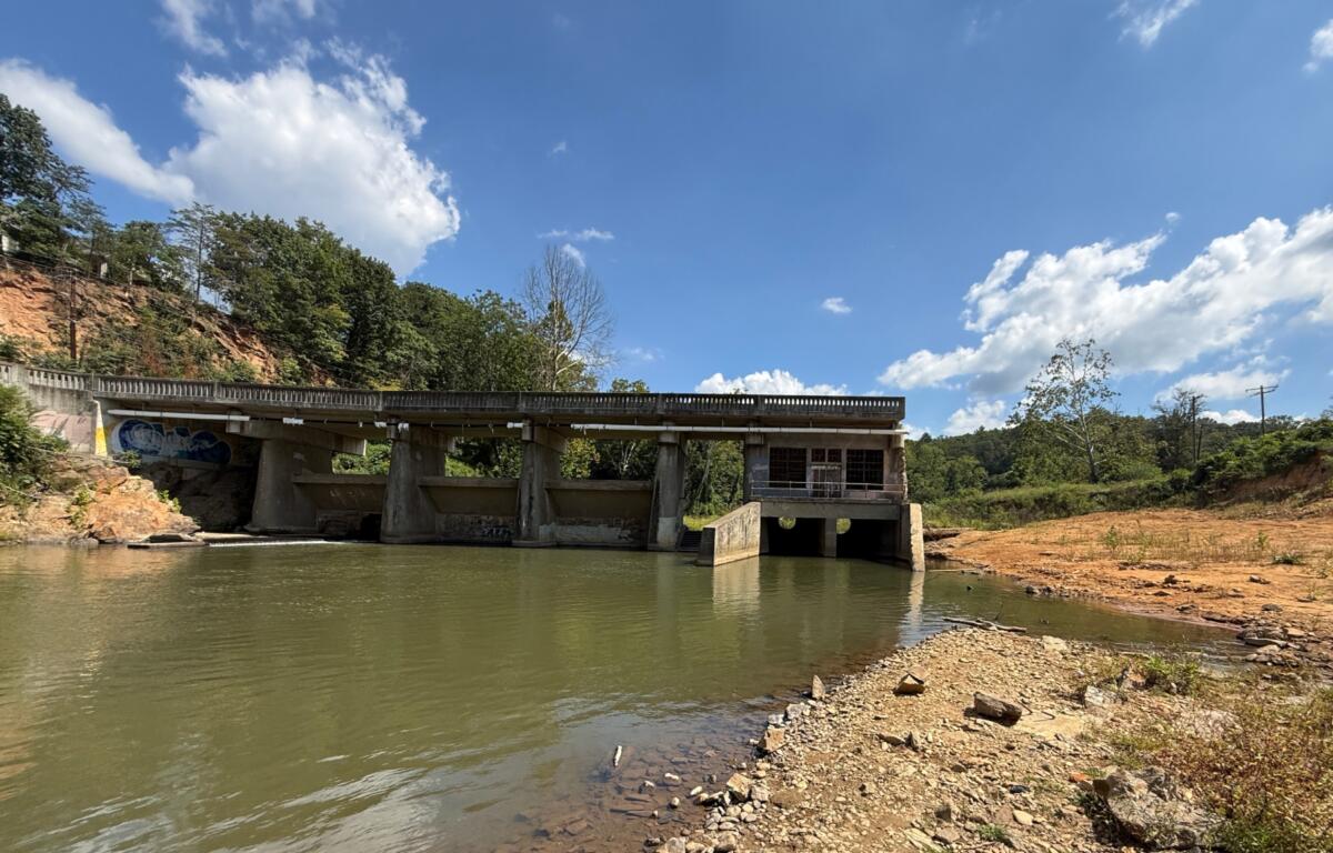 Lake Craig Dam spans the Swannanoa River in Asheville. Hurricane Helene partially washed out the century-old dam, creating an opening that has allowed fish to reach upstream habitat that had been blocked for more than 100 years.