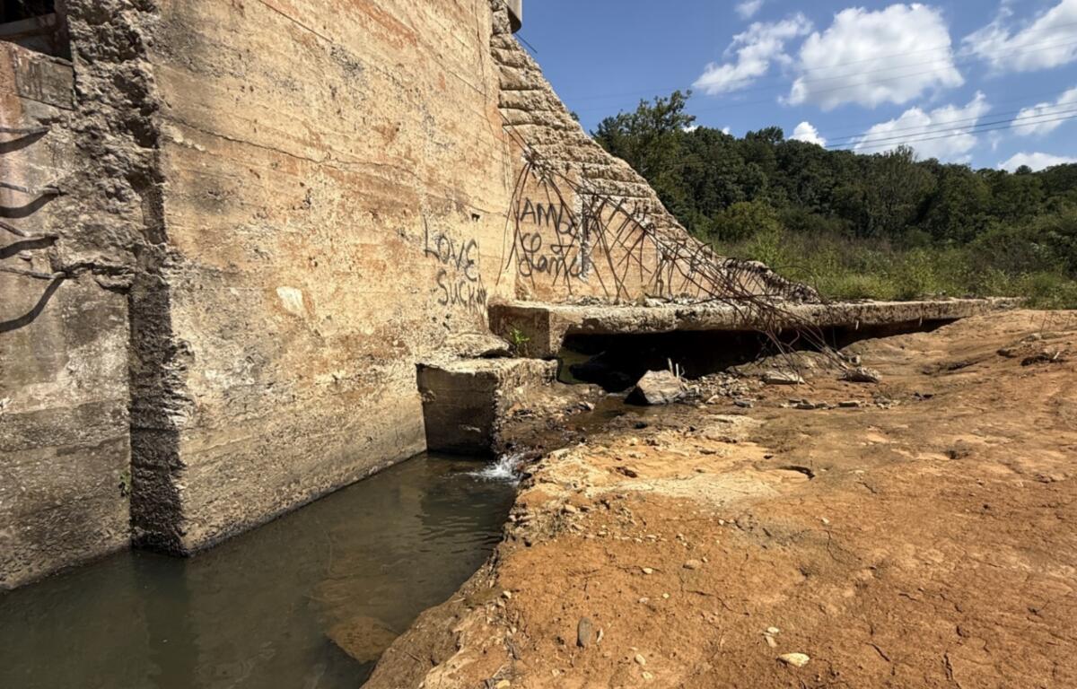 Water flows through an opening created when Hurricane Helene damaged Lake Craig Dam in Asheville. Researchers have since documented fish upstream of the dam that had not been found there since the barrier was built more than a century ago.